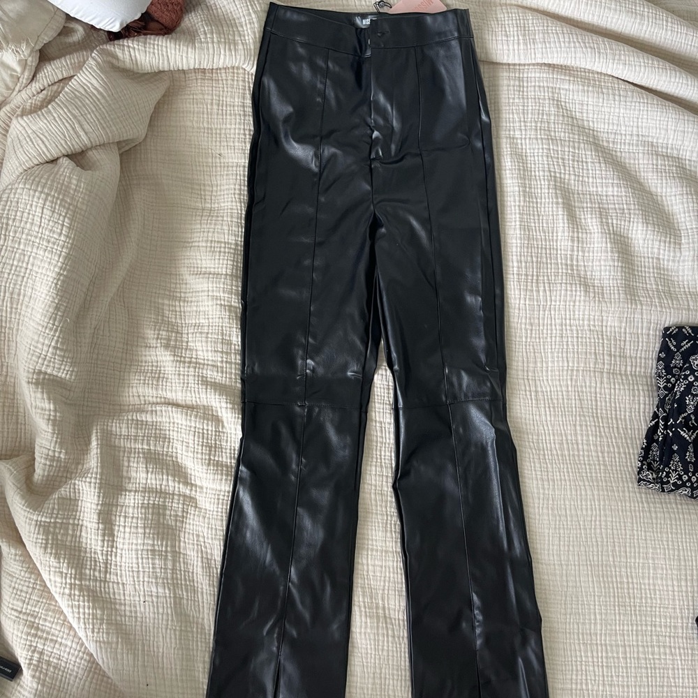 Black faux leather pants with slit at bottom. New w/ tags size US 2